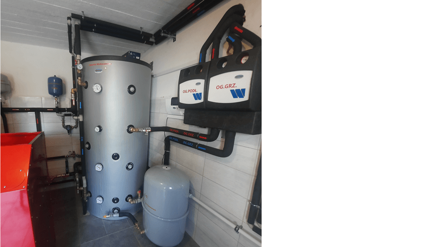 WATTS HK25 and HKM25 pump groups with a VB25/32-2 boiler manifold, connected to a large buffer tank and expansion vessel, ensuring efficient distribution for underfloor and radiator heating.