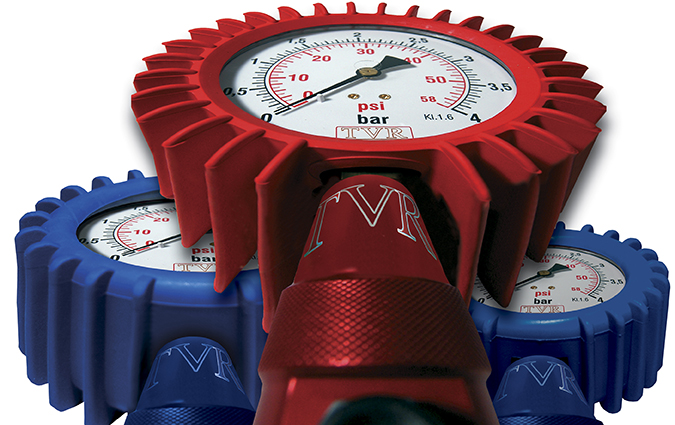 Three WATTS Ordeo pressure gauges with shock-resistant casings, two in blue and one in red, featuring engraved TVR branding and precision dials displaying measurements in bar and psi for accurate tire pressure monitoring.