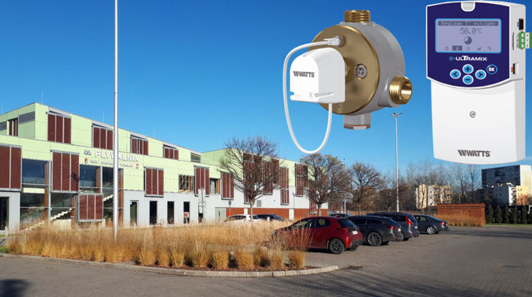 Exterior view of a modern swimming pool facility equipped with the WATTS e-ULTRAMIX electronic mixing valve system.