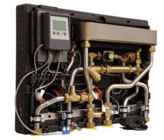 Watts HIU Heat Comfort E heat interface unit, internal view with plate heat exchanger, circulator pumps, brass valves, and LCD controller, left-side front perspective.
